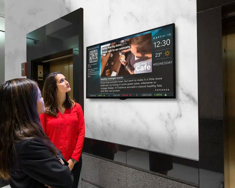 Digital advertising displayed on a screen inside a local business